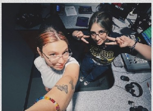 Two students pose for photo in radio station