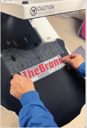 The Bronc logo is placed on a piece of clothing