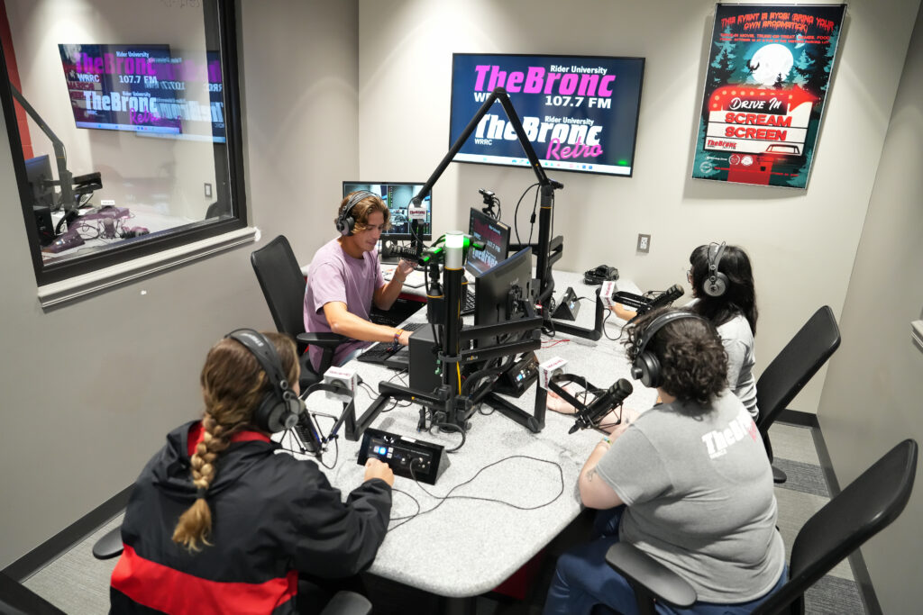 Kadie, Bella, Grace, and Dan recording in the studio