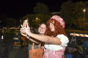 Girls in costume posing at scream screen